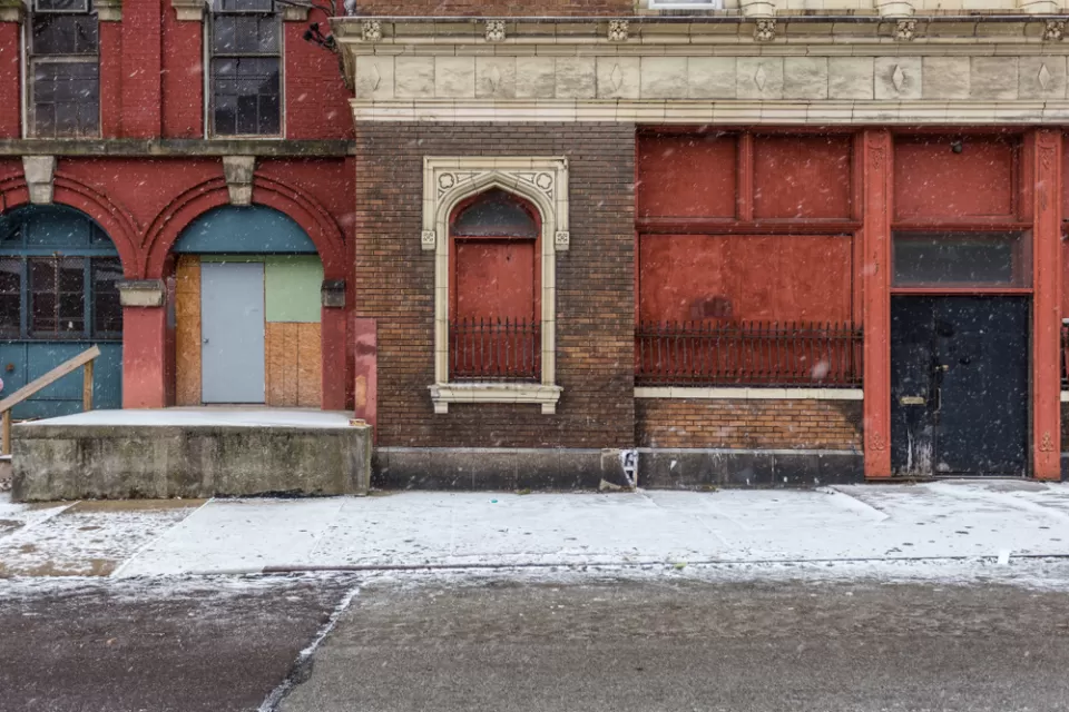Boarded-up facade of vacant brick building in CIncinnati, Ohio